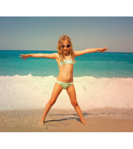 Child on the beach. Girl at vacations on sea