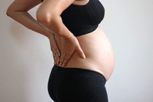 Asian woman pregnant belly with back pain