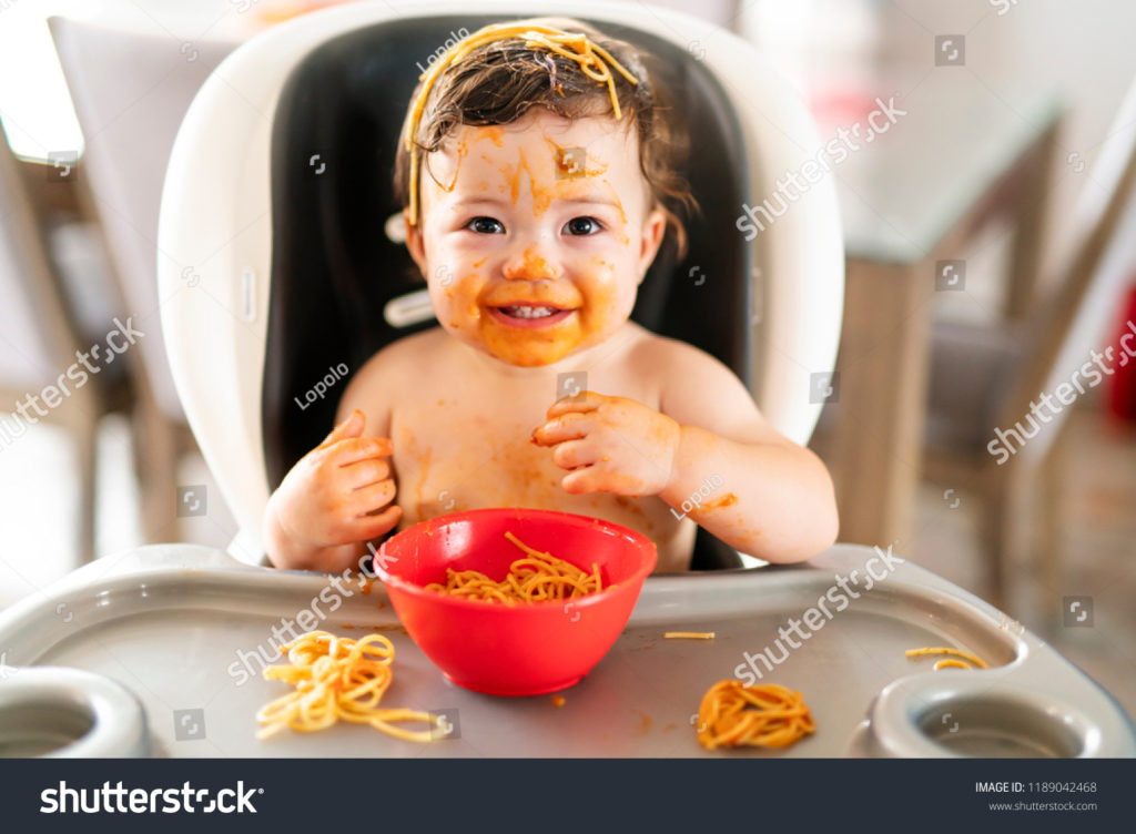 stock-photo-child-girl-eating-spaghetti-for-lunch-and-making-a-mess-at-home-in-kitchen-1189042468